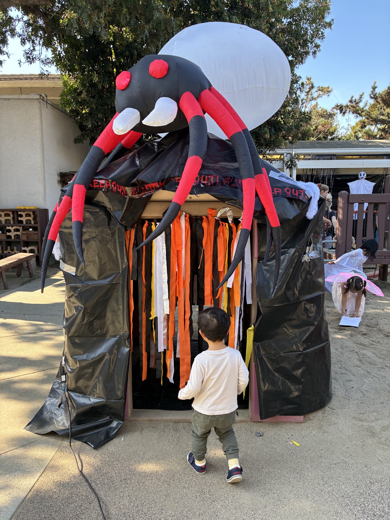 Children in festive costumes participating in the UPNS Halloween parade.