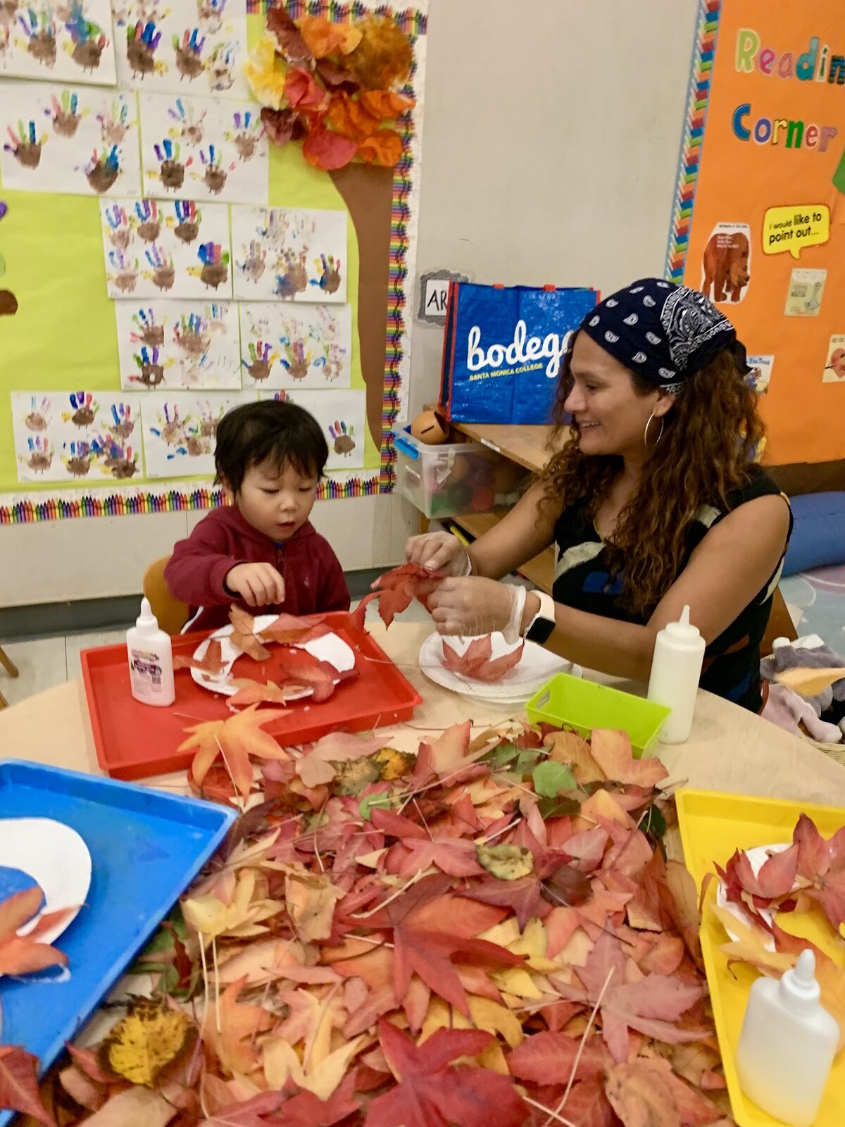 Toddlers exploring leaves and nature in the Kitten Room