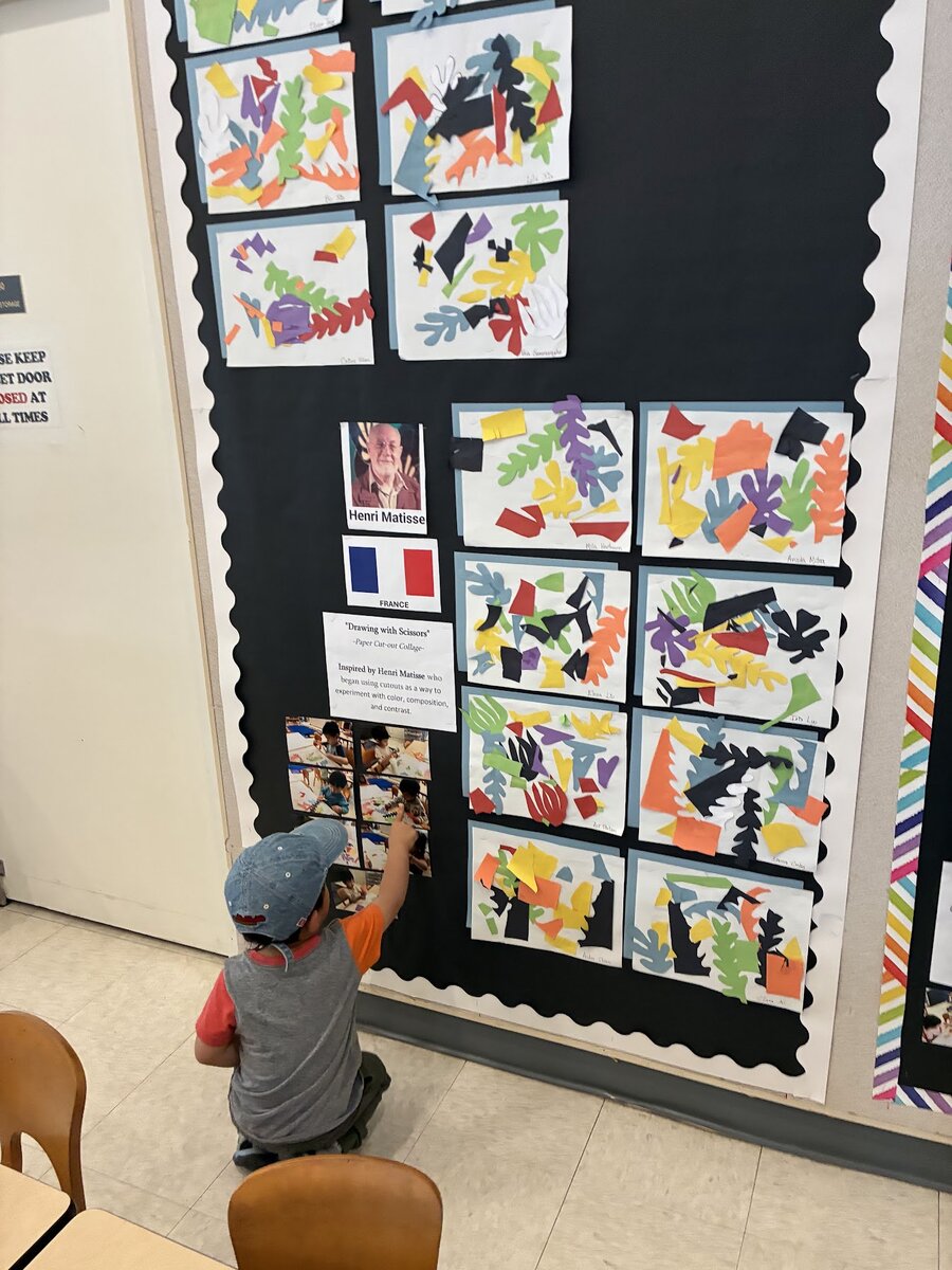 Toddlers creating and displaying their colorful artwork in the Kitten Room
