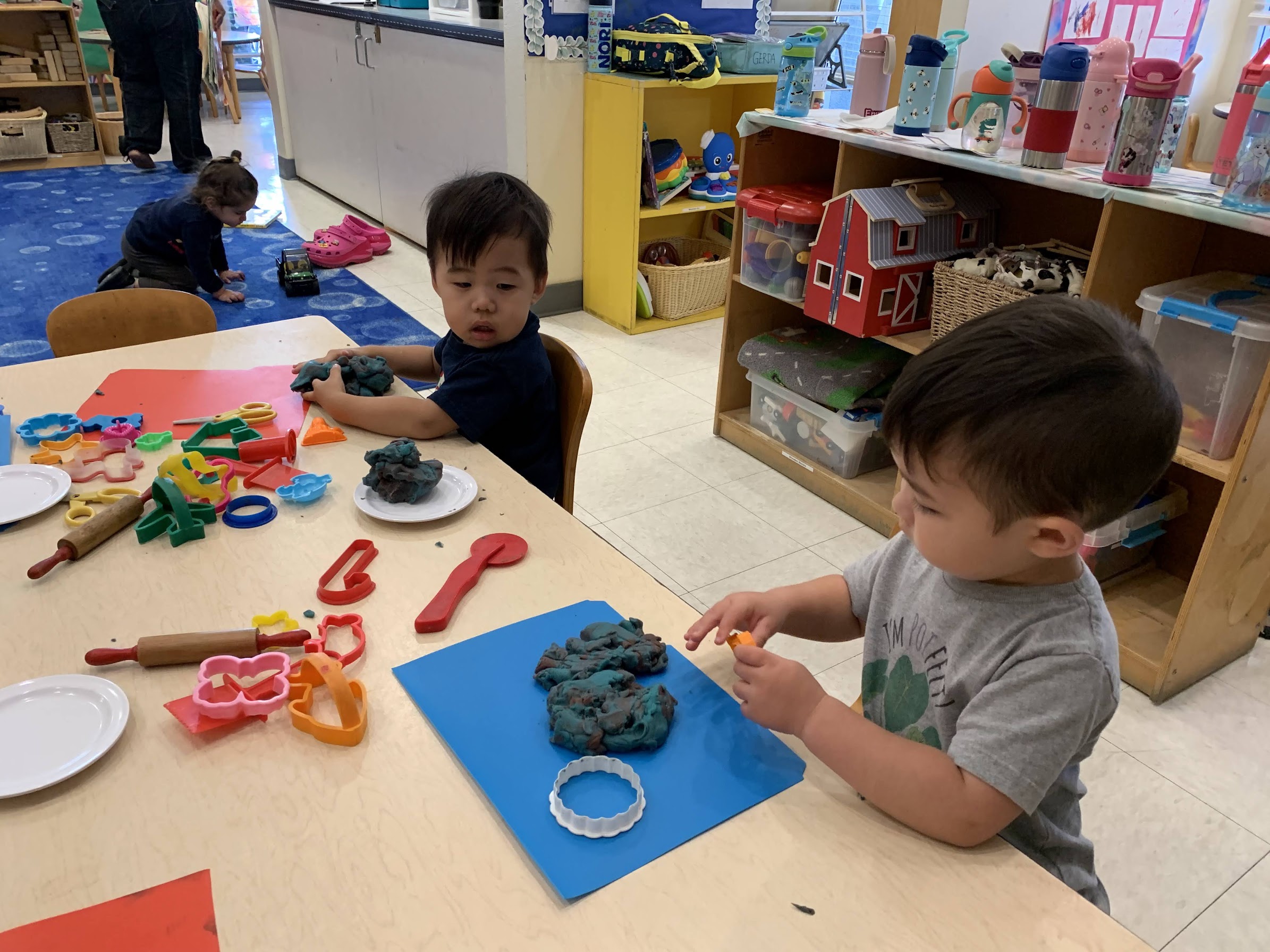 Toddlers creating and playing with playdough in the Kitten Room